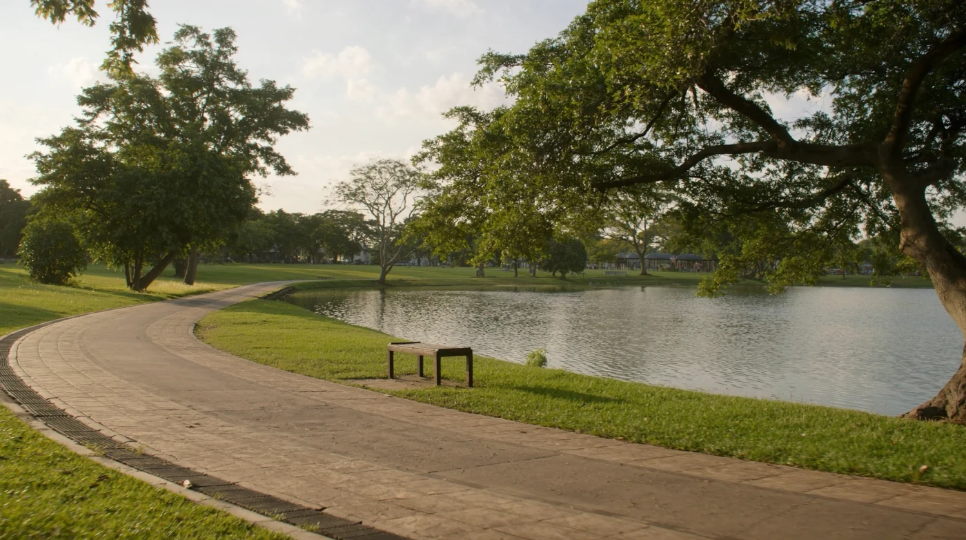Cycle path and bench beside the lake at Rot Fai Park in Bangkok