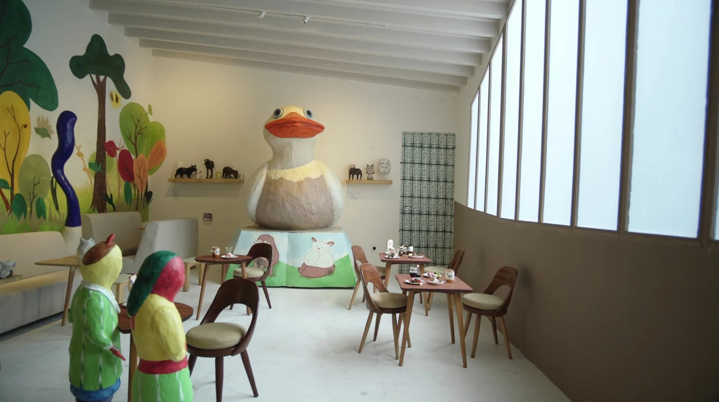 Gallery cafe with colourful sculptures and storybook murals in Bangkok