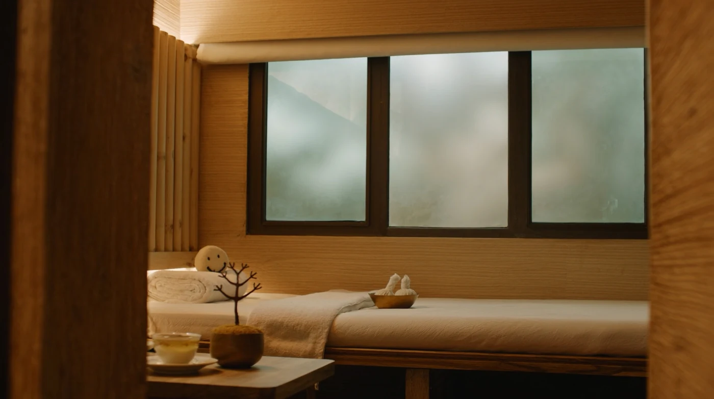Thai spa treatment room with herbal compress balls and folded towels