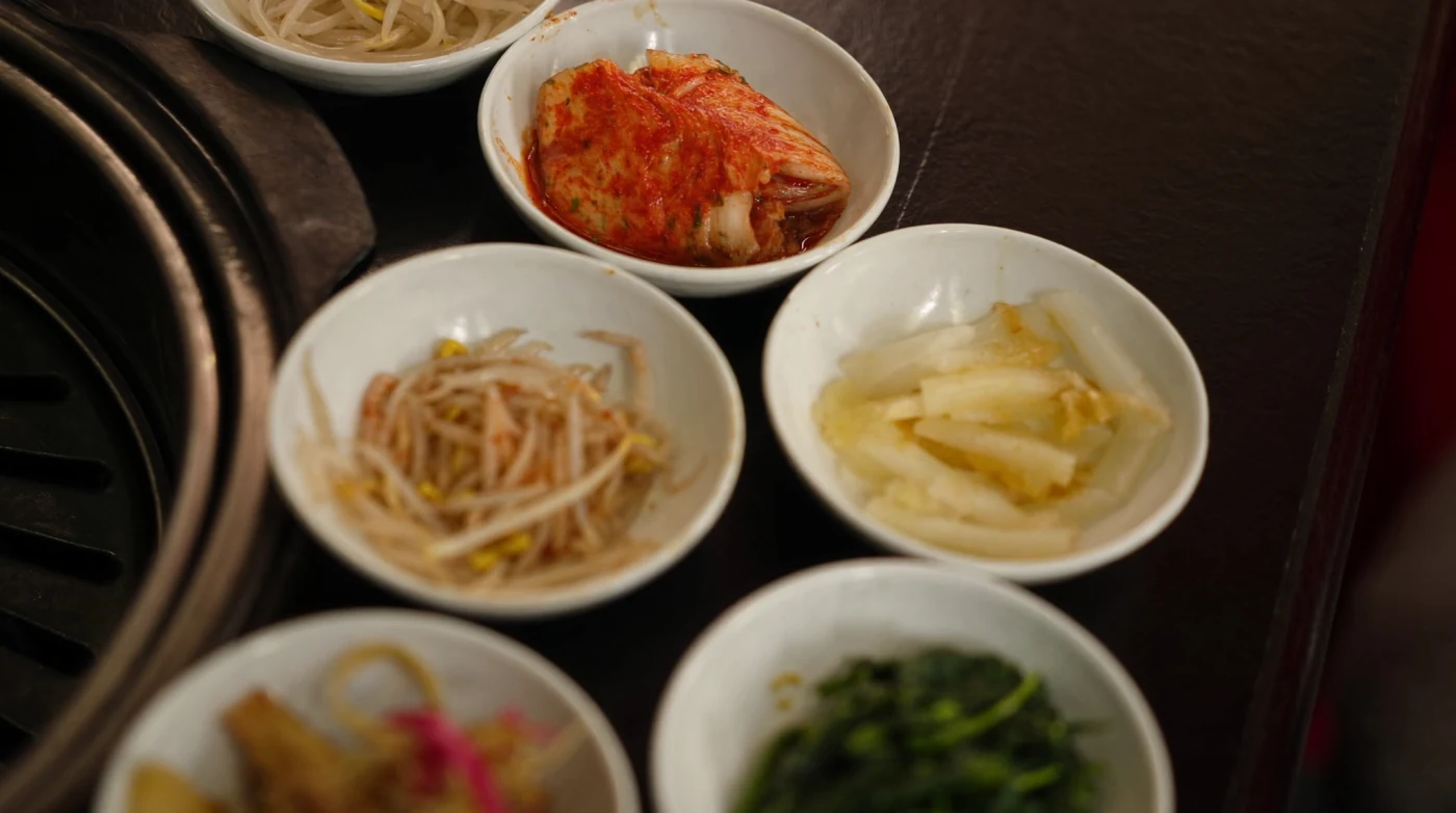 Row of small banchan side dishes on a Korean barbecue table