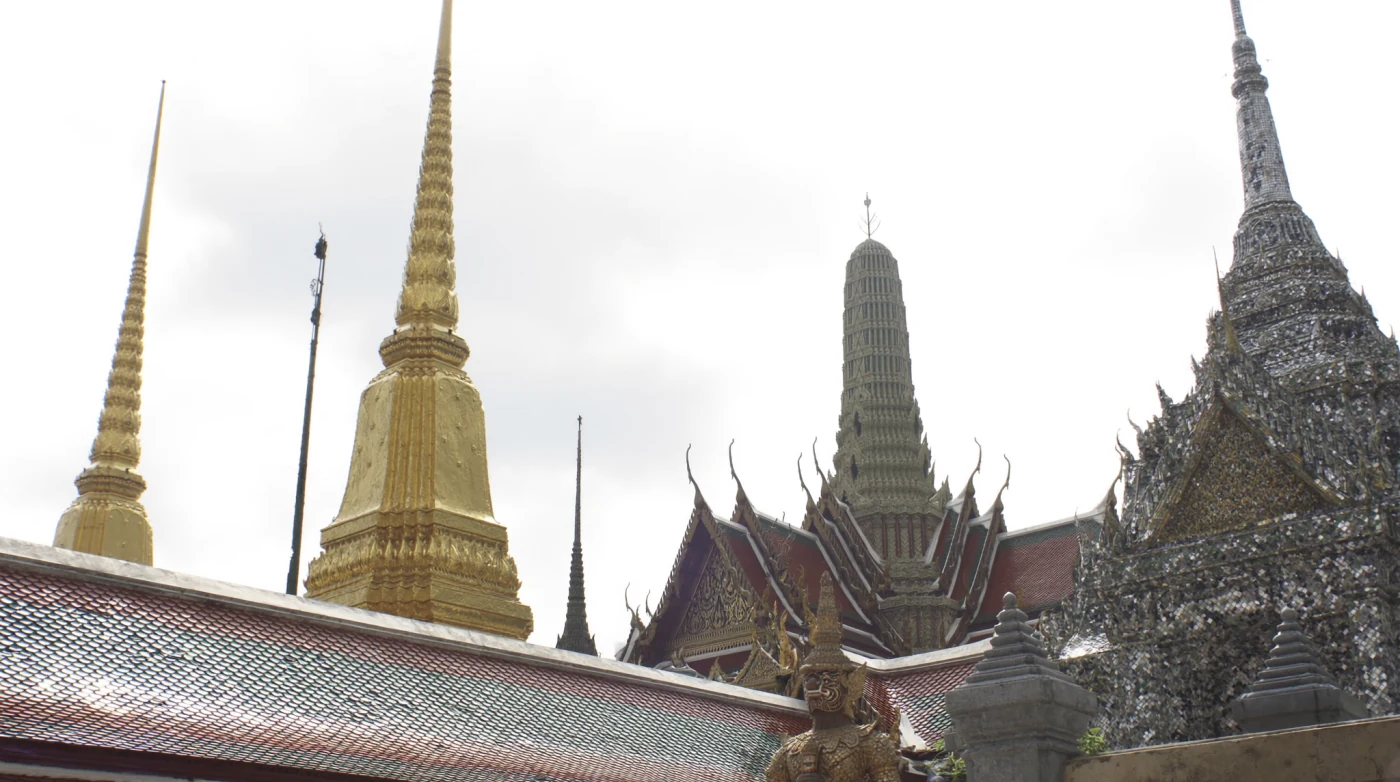 Gold spires and tiered temple roofs inside the Grand Palace complex in Bangkok